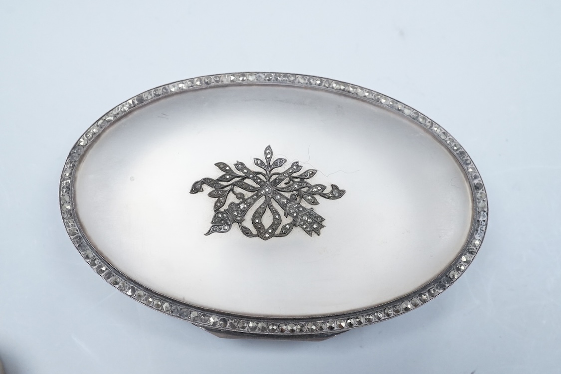A continental 935 standard white metal oval box, with inset frosted glass and marcasite set hinged cover, 82mm, together with three assorted small pill boxes, including enamelled(a.f.), an Italian 800 standard and a mode